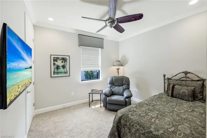 Bedroom with light colored carpet, crown molding, a ceiling fan, and recessed lighting