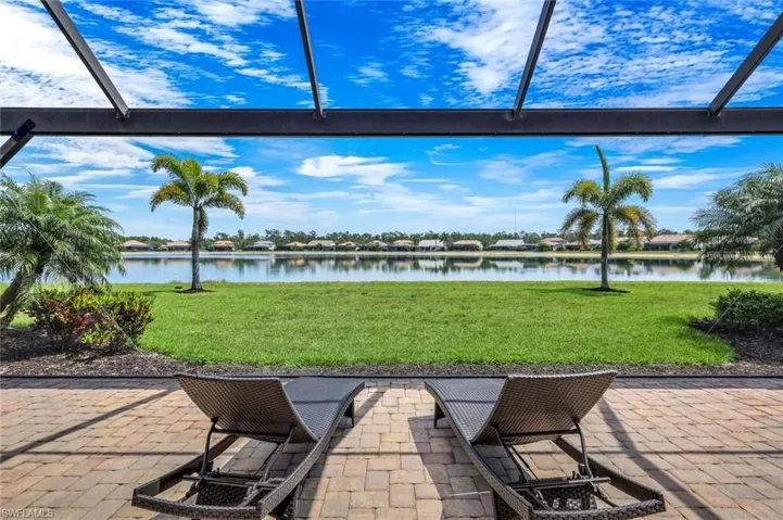 View of patio with picture window screen enclosure and a water view