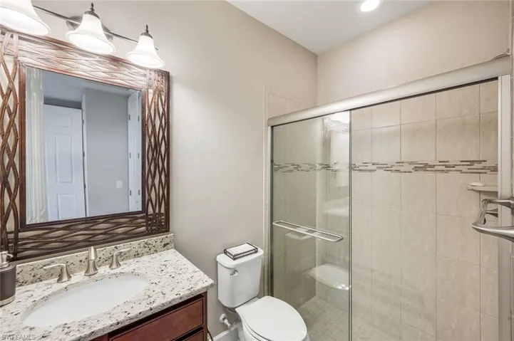 Full bathroom with vanity and a shower stall