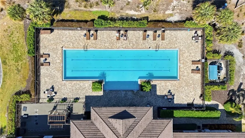 Community aquatic area featuring a large rectangular swimming pool and a separate spa