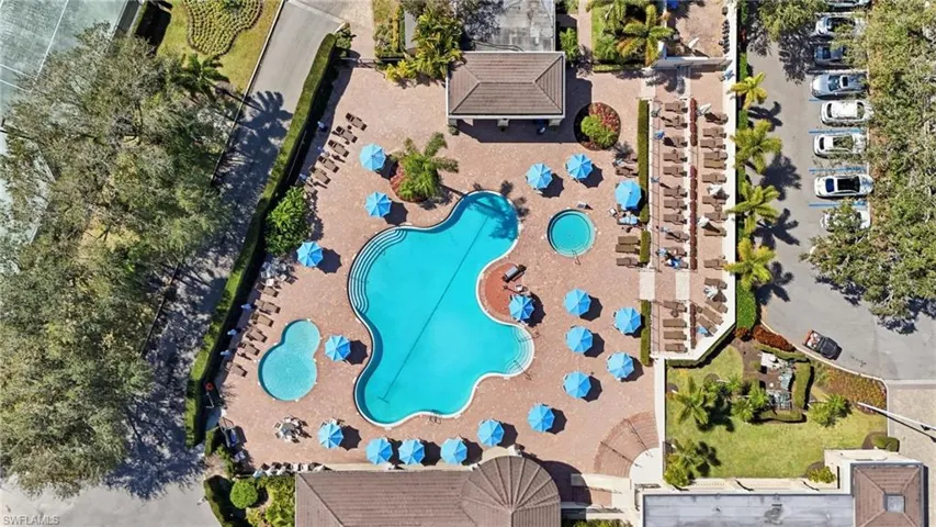 Expansive pool area featuring a freeform swimming pool, a smaller secondary pool, and a circular spa