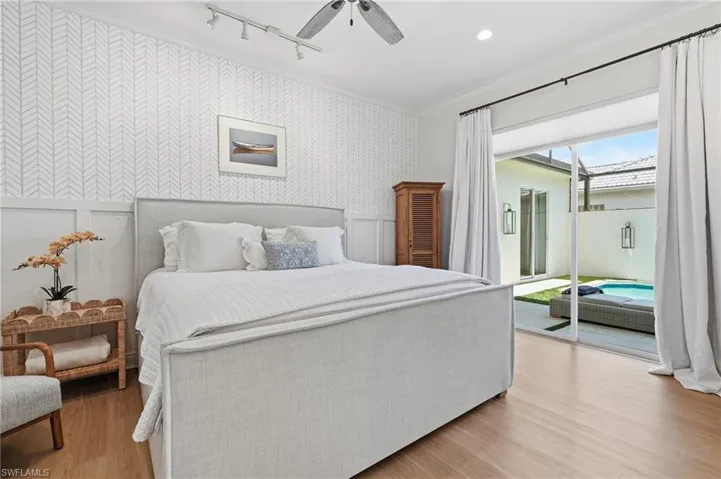 Bedroom featuring direct access to an outdoor living area with a private pool