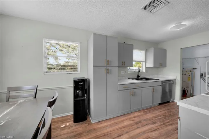 Kitchen with visible vents, gray cabinetry, and dishwasher