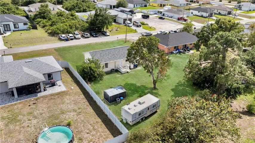 View of yard with central AC and a deck