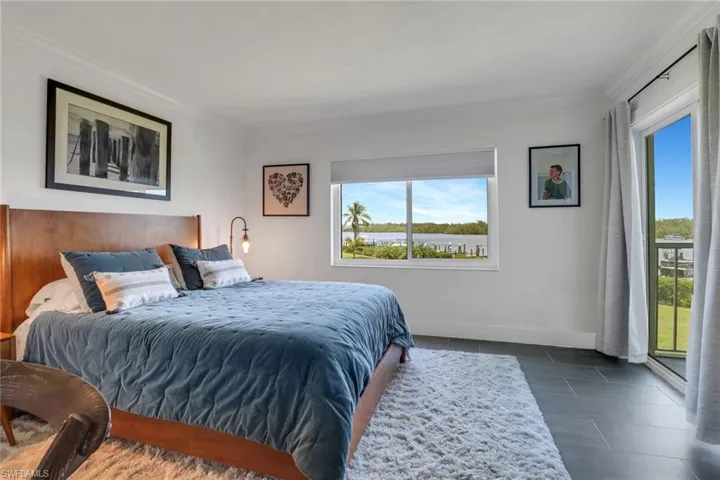 Primary bedroom with views of the Gordon River and opening to lanai