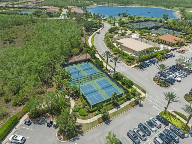 Aerial perspective showcasing multiple recreational courts, a paved roadway, and extensive landscaping