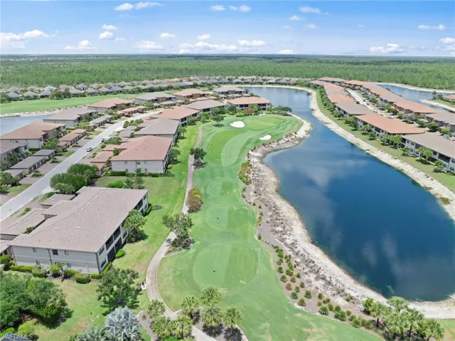 Aerial perspective showcasing a residential community with golf course frontage and waterside properties