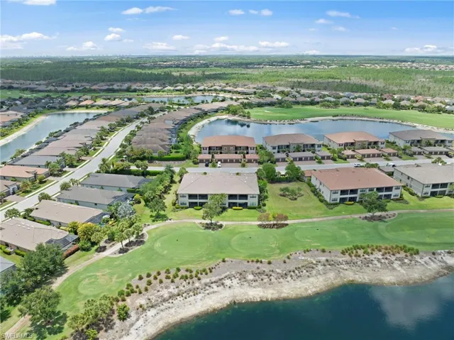 Aerial perspective showcasing a residential community with abundant green spaces, multiple water features, and an integrated golf course