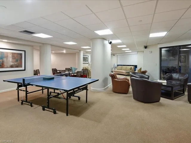 Rec room with light carpet and a paneled ceiling