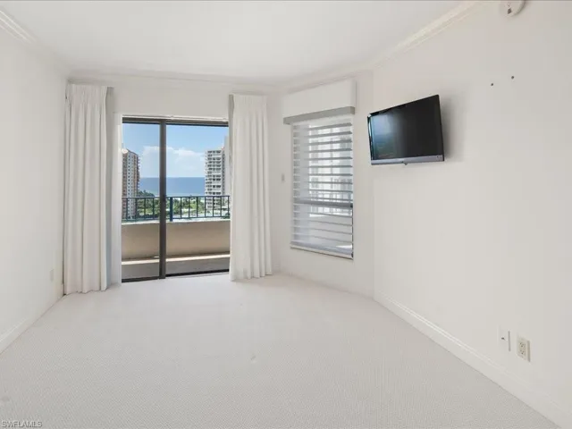 Unfurnished room featuring ornamental molding and light colored carpet