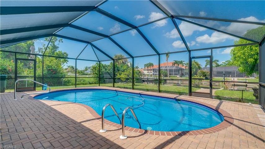 Beautiful paver decking around pool and down to dock.
