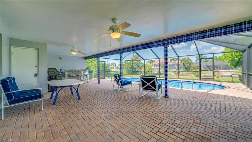 Huge Lanai with entrance to garage, bar area, and pool.