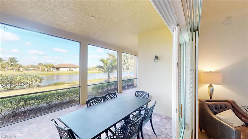 Sunroom with plenty of natural light and a water view