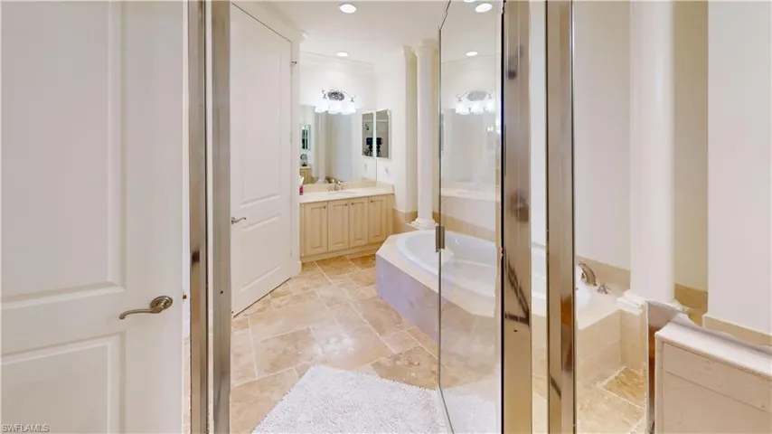Bathroom with independent shower and bath, vanity, and decorative columns