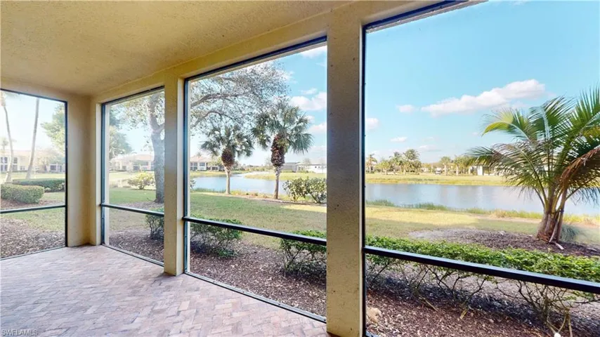 Unfurnished sunroom featuring a water view