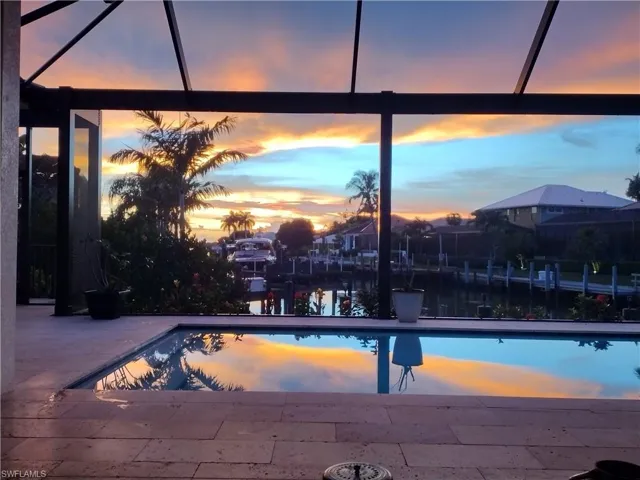 Pool at dusk withexpansive Lanai including dining area, Outdoor BBQ, Lounge and seating area too.