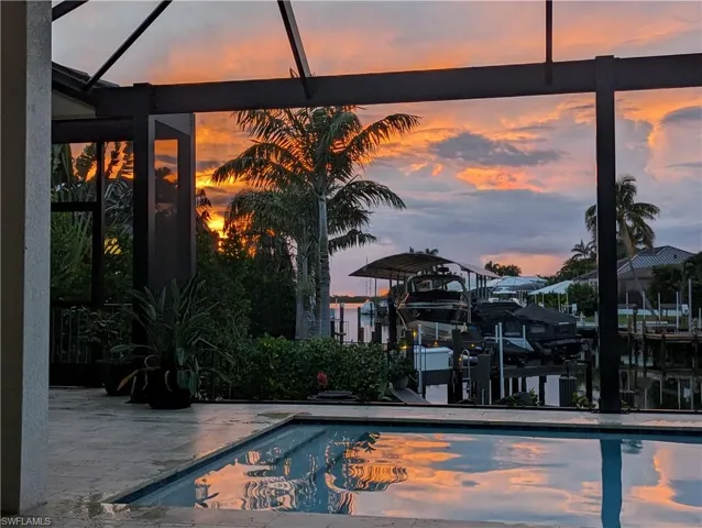 Pool at dusk featuring a patio