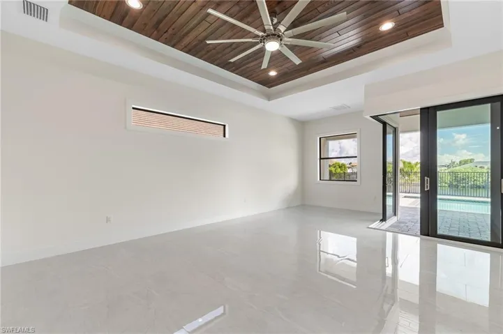 Unfurnished room featuring wood ceiling, a tray ceiling, recessed lighting, and a ceiling fan