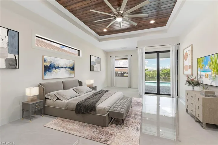 Bedroom featuring wooden ceiling, access to outside, a tray ceiling, recessed lighting, and ceiling fan