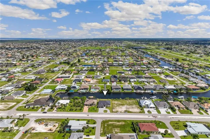 Aerial perspective of suburban area with a nearby body of water