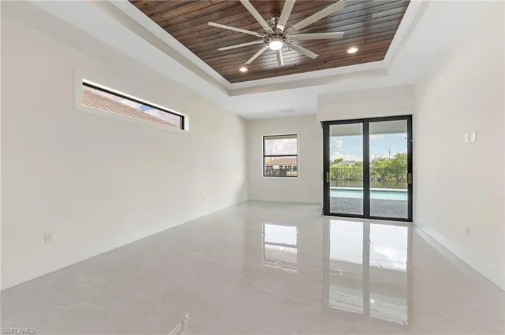 Unfurnished room featuring wood ceiling, a tray ceiling, recessed lighting, and a ceiling fan