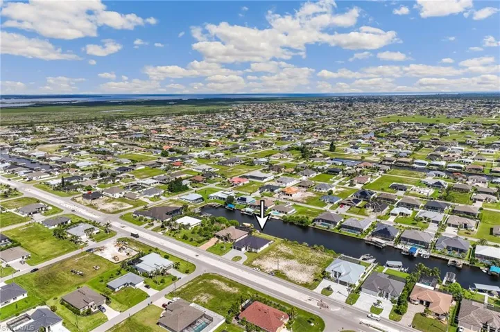 Aerial perspective of suburban area with a nearby body of water