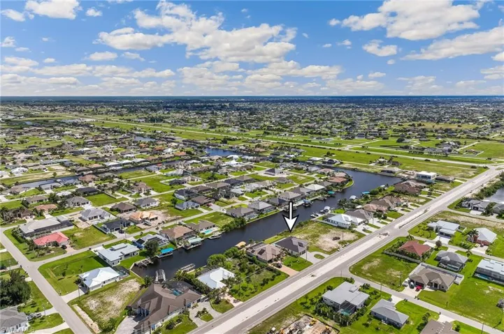 Aerial overview of property's location with a large body of water and nearby suburban area