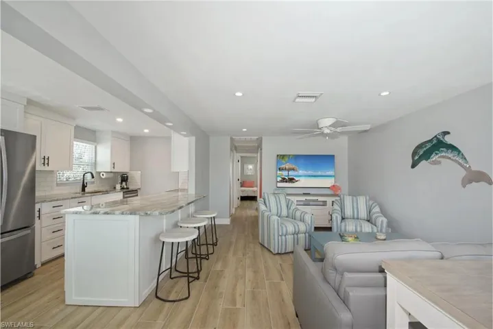 Well-equipped kitchen featuring modern cabinetry and ample counter space (Beach home 1)  - Virtually Edited Image
