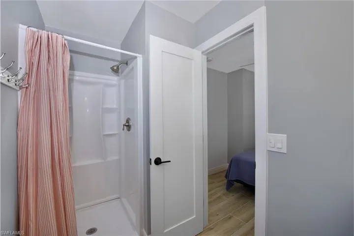 Modern bathroom with a luxurious walk-in shower and sleek fixtures (Beach home 2) - Virtually Edited Image