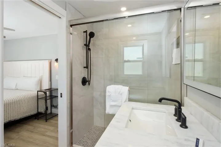Well-designed bathroom featuring contemporary finishes and ample storage space (Beach home 1) - Virtually Edited Image