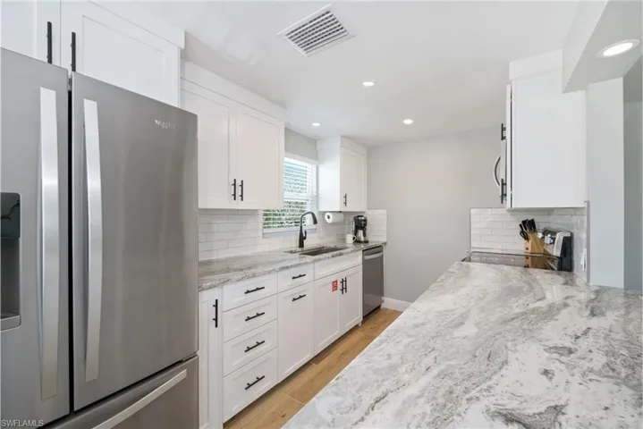 Well-equipped kitchen with a functional layout, perfect for preparing meals and entertaining guests (Beach home 1)  - Virtually Edited Image