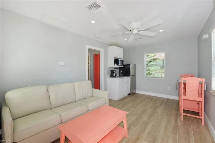 Spacious living area with ample natural light, perfect for entertaining or relaxing (Beach home 2) - Virtually Edited Image