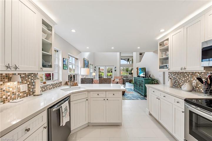 Chefs Kitchen with Custom Cabinets, Quartz counters, Stainless appliances and Stone backsplash