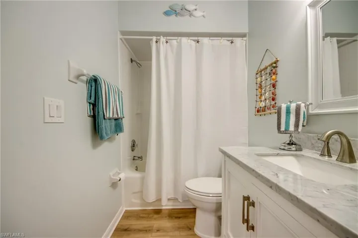 GUEST BATHROOM WITH LINEN CLOSET.