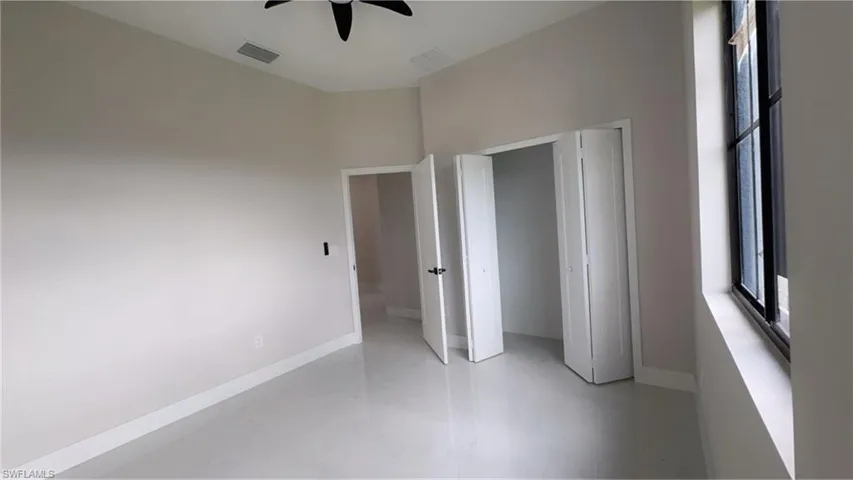 Unfurnished bedroom with baseboards and a ceiling fan
