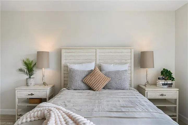 Bedroom with light wood finished floors and baseboards