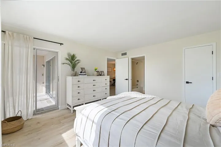 Bedroom with access to outside and light wood-style flooring