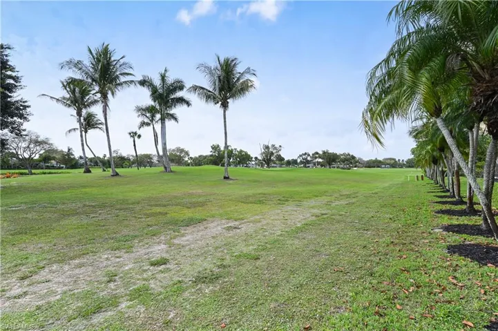 View of green lawn featuring golf course view