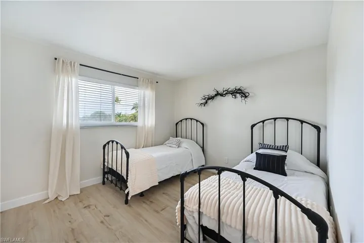 Bedroom with light wood-type flooring and baseboards