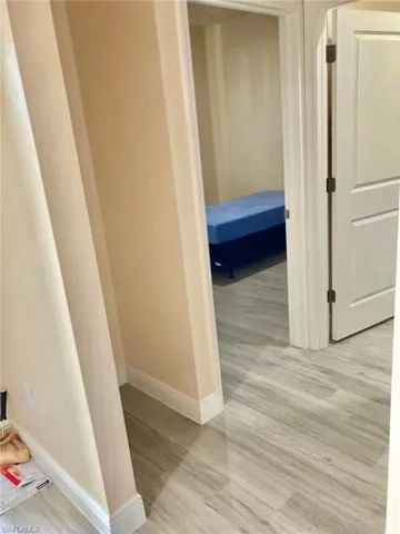 Hallway with light hardwood / wood-style flooring