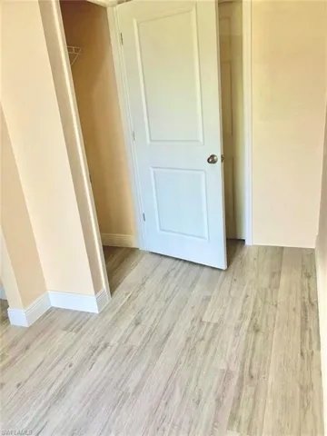 Unfurnished bedroom with light wood-type flooring and a closet
