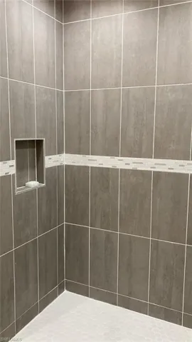 Bathroom featuring tiled shower