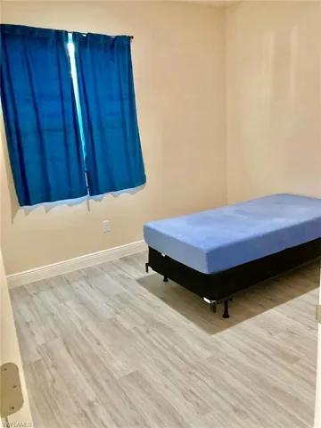 Unfurnished bedroom featuring light wood-type flooring