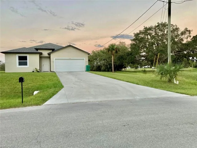 View of front of house featuring a yard and a garage