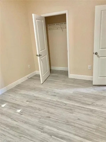 Unfurnished bedroom with a closet and light hardwood / wood-style floors