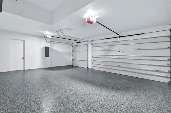 Garage with electric panel and a garage door opener