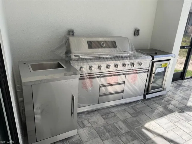 View of patio featuring a grill and an outdoor kitchen