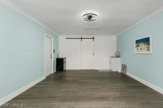 Bathroom featuring vanity, vaulted ceiling, toilet, baseboards, and a stall shower