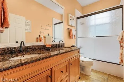 Kitchen featuring white cabinetry, stainless steel appliances, a sink, a kitchen island with sink, and wood finished floors