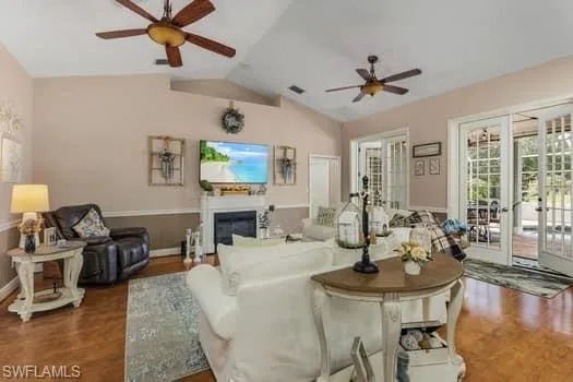 Dining area with ornamental molding, baseboards, arched walkways, and wood finished floors